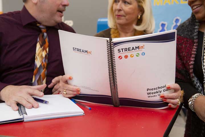 A teacher and principal reviewing data and the curriculum.